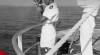 Foto seorang perwira navigasi sedang melakukan pengukuran navigasi dengan alat sextant didamping nahkoda kapal Widuri milik Djawatan Pelayaran, tanggal 14 Juni 1954.