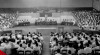 Foto suasana saat Wali Kota Jakarta Raya Raden Sudiro menyampaikan sambutan pada upacara pembukaan Kongres Rukun Kampung Seluruh Jakarta Raya di Gedung Olahraga, 28 Juni 1955.
